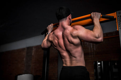 A man doing pull-ups during a body building session.